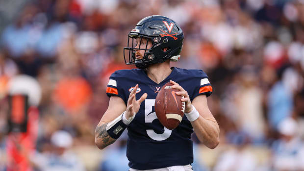 Virginia quarterback Brennan Armstrong dropping back to pass the football.